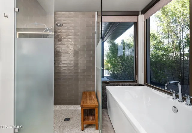 a bedroom with two beds and a large window