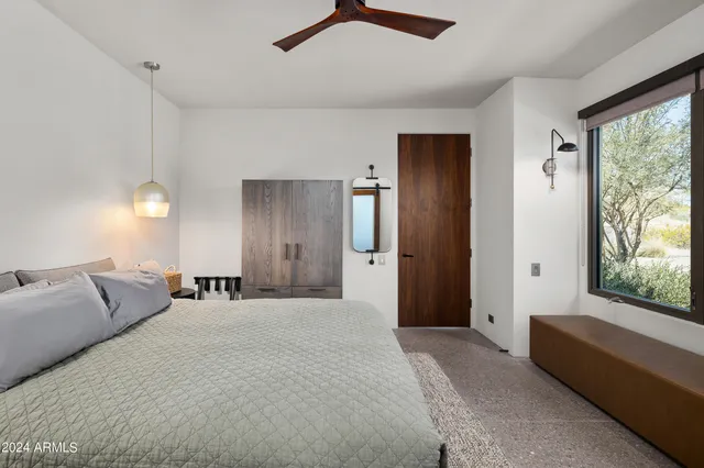 a bedroom with a bed and window