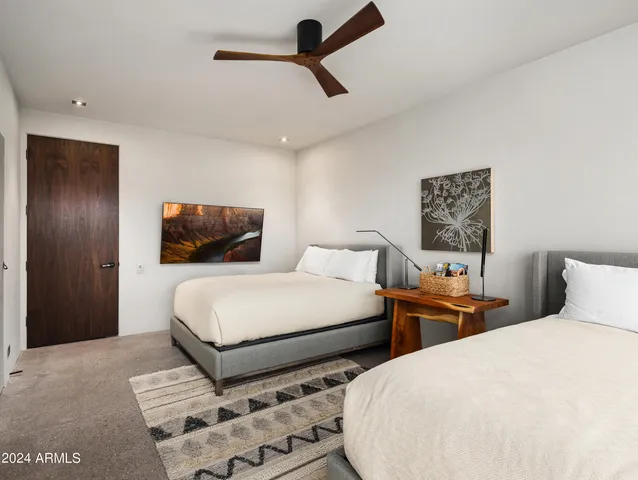 a bedroom with a bed and a table lamp