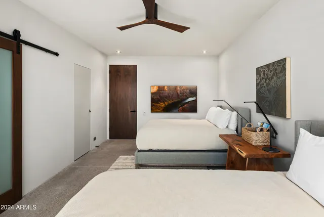 a bedroom with a bed and a large window