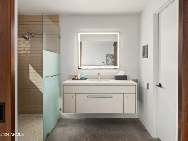 a bedroom with a large bed and a couch