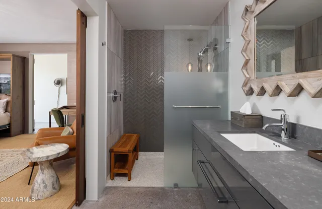 a swimming pool with outdoor seating and yard in the back