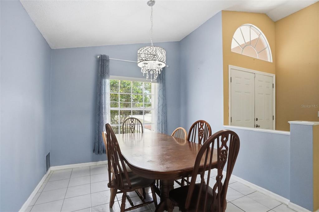 4219 Newton Road Spring Hill, FL 34606 - Photo 14 of 35 a view of a dining room with furniture and chandelier