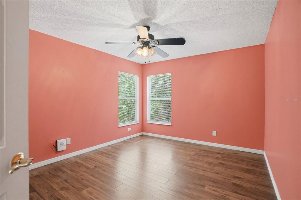 4219 Newton Road Spring Hill, FL 34606 - Photo 23 of 35 an empty room with a window and a fan