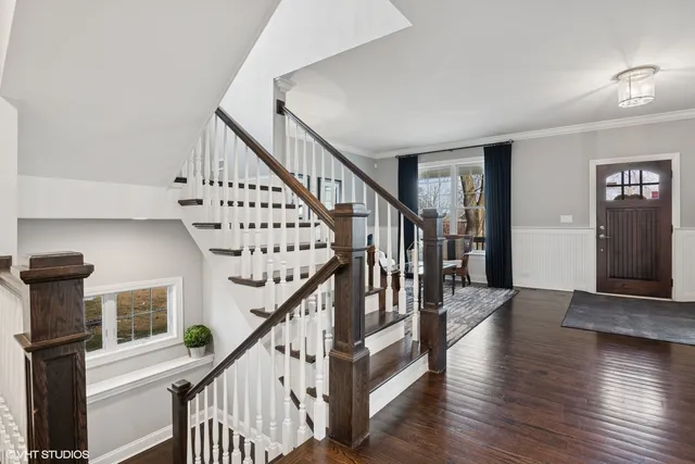 a kitchen with stainless steel appliances granite countertop a refrigerator a stove and white cabinets
