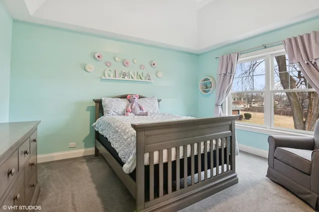 a bedroom with a bed chair and a window