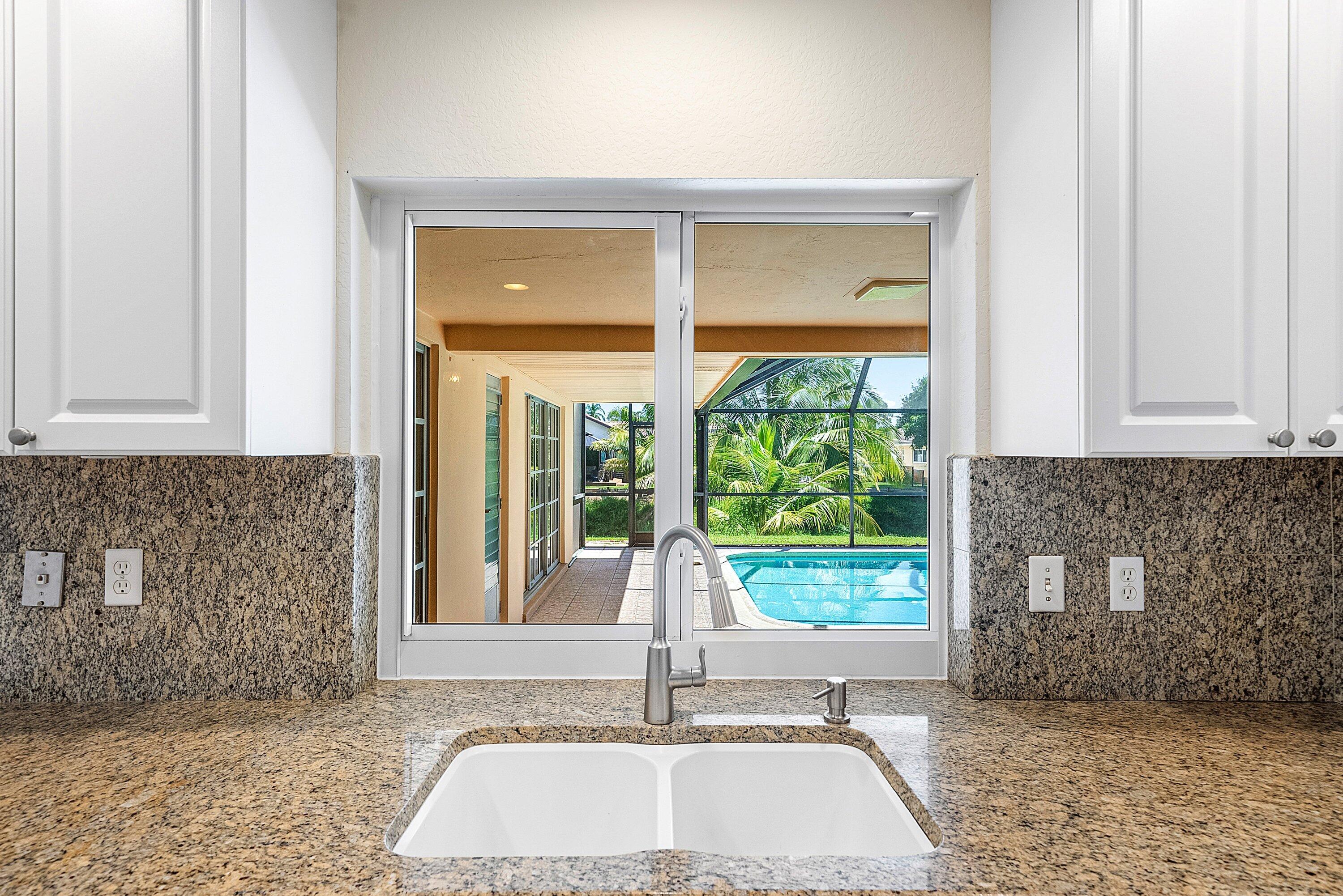480 Northwest 11th Avenue Boca Raton, FL 33486 - Photo 13 of 43 a view of a sink and an empty room with a fireplace
