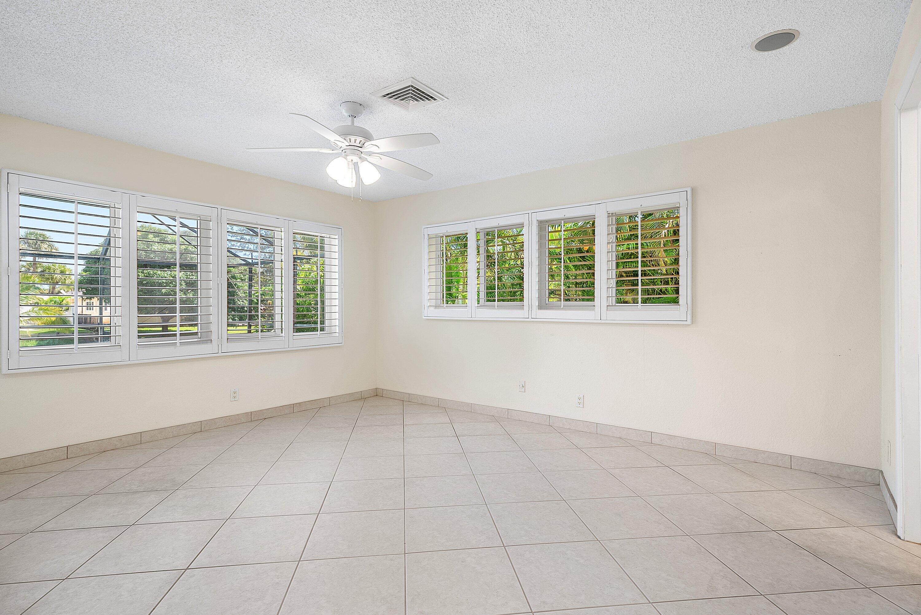 480 Northwest 11th Avenue Boca Raton, FL 33486 - Photo 16 of 43 an empty room with windows and ceiling fan