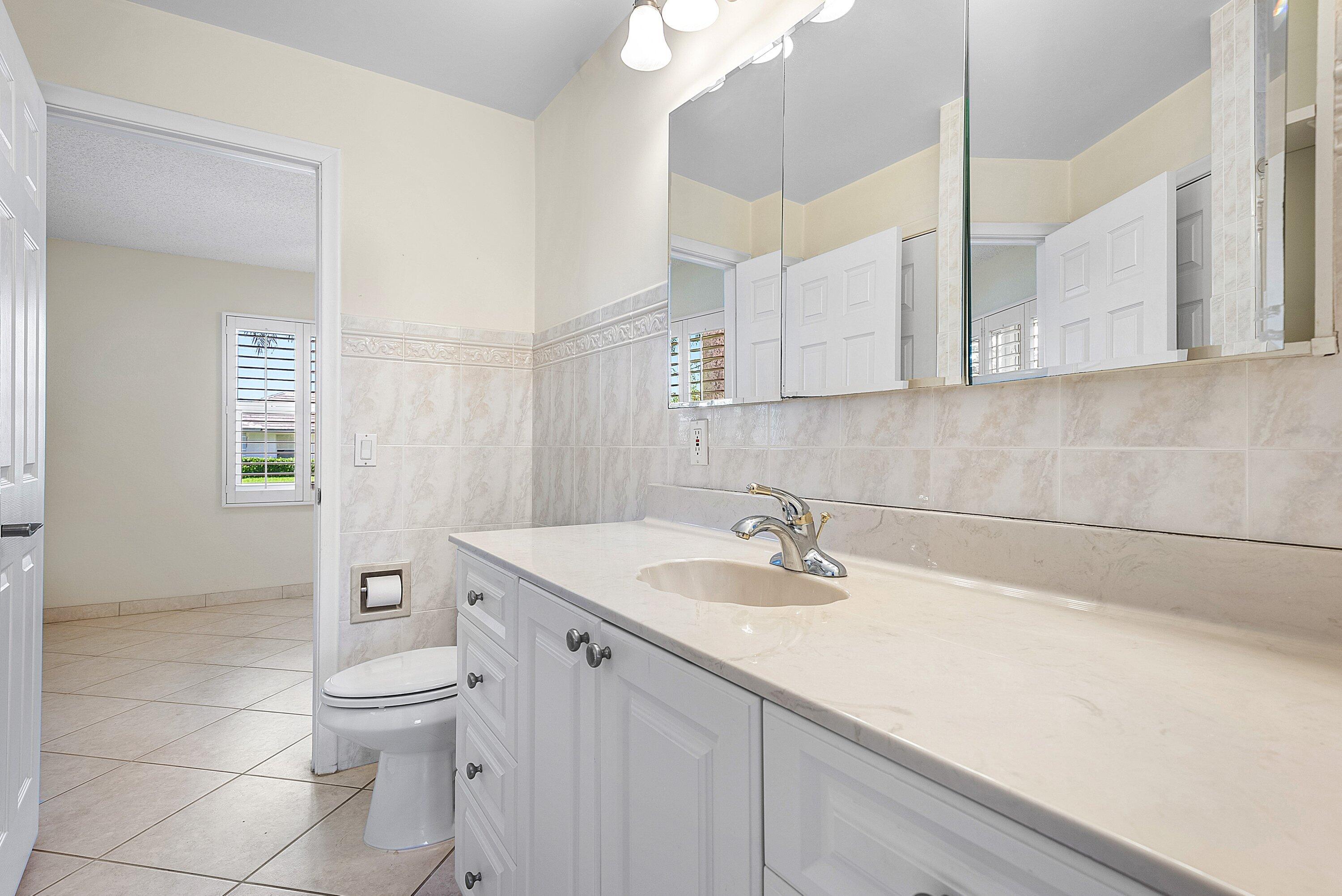 480 Northwest 11th Avenue Boca Raton, FL 33486 - Photo 20 of 43 a bathroom with a sink a toilet and shower