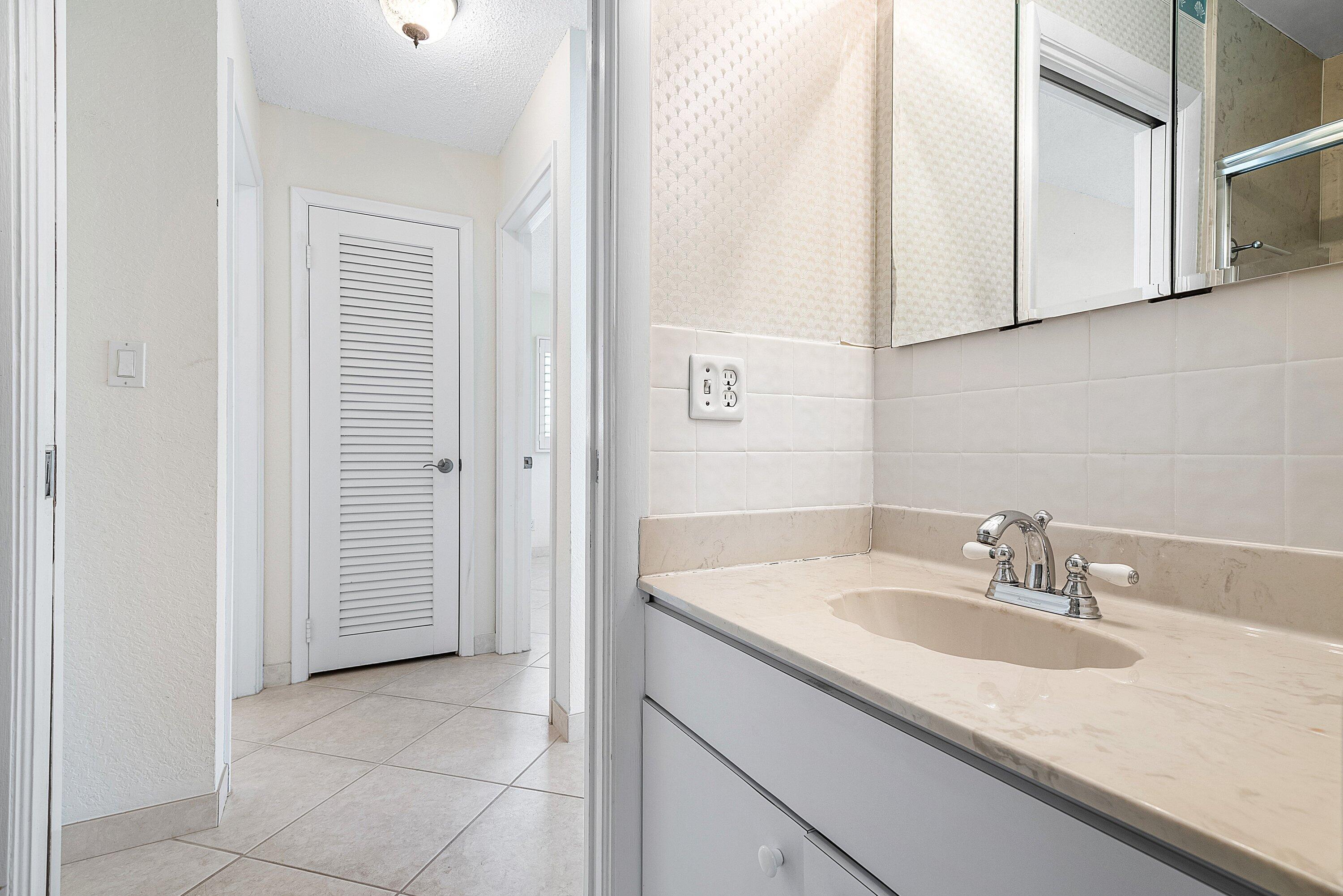 480 Northwest 11th Avenue Boca Raton, FL 33486 - Photo 30 of 43 a bathroom with a sink and a mirror