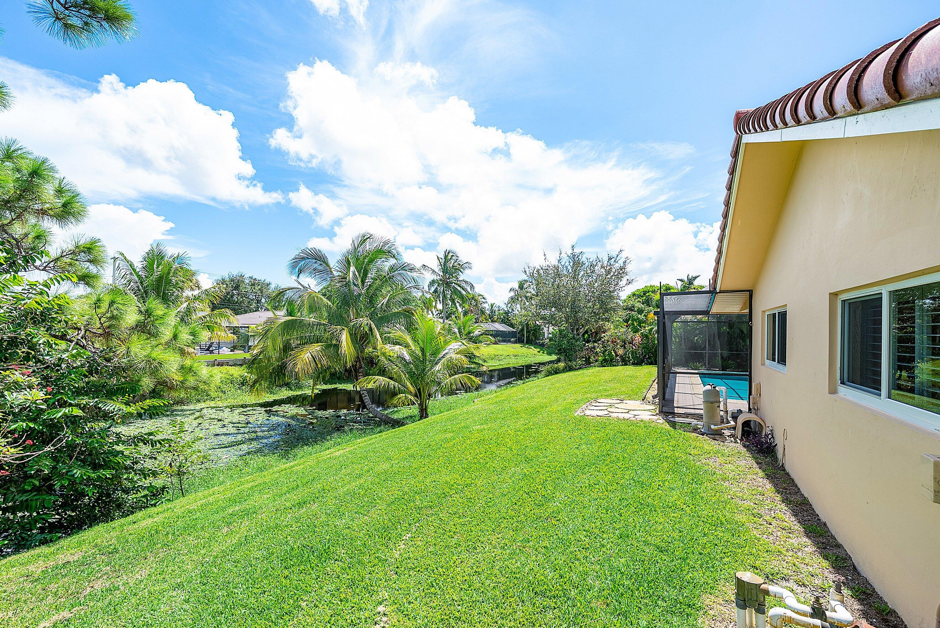 480 Northwest 11th Avenue Boca Raton, FL 33486 - Photo 36 of 43 a view of a backyard with plants and a patio