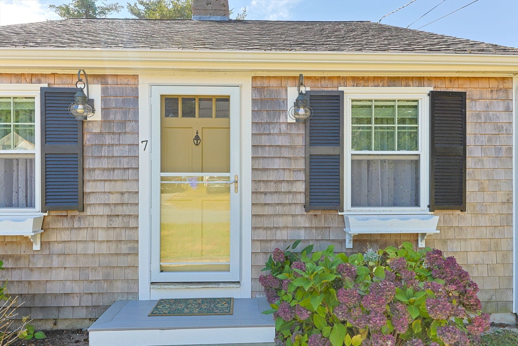 7 Spruce Drive Bourne, MA 02559 - Photo 2 of 39 a front view of a house with a yard