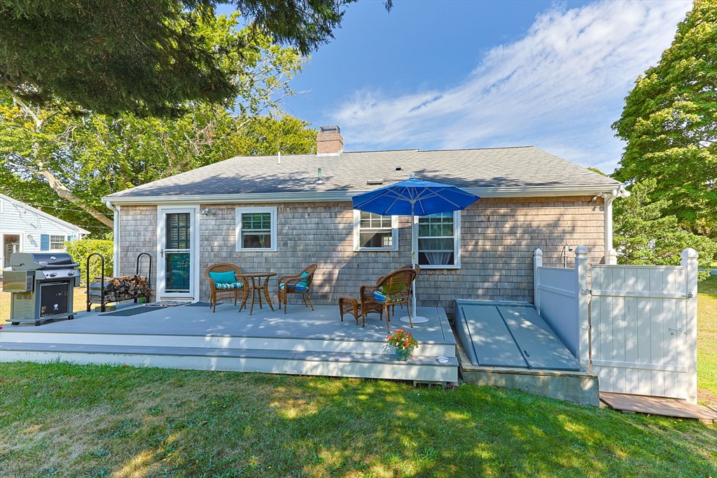 7 Spruce Drive Bourne, MA 02559 - Photo 23 of 39 a front view of house with yard and outdoor seating