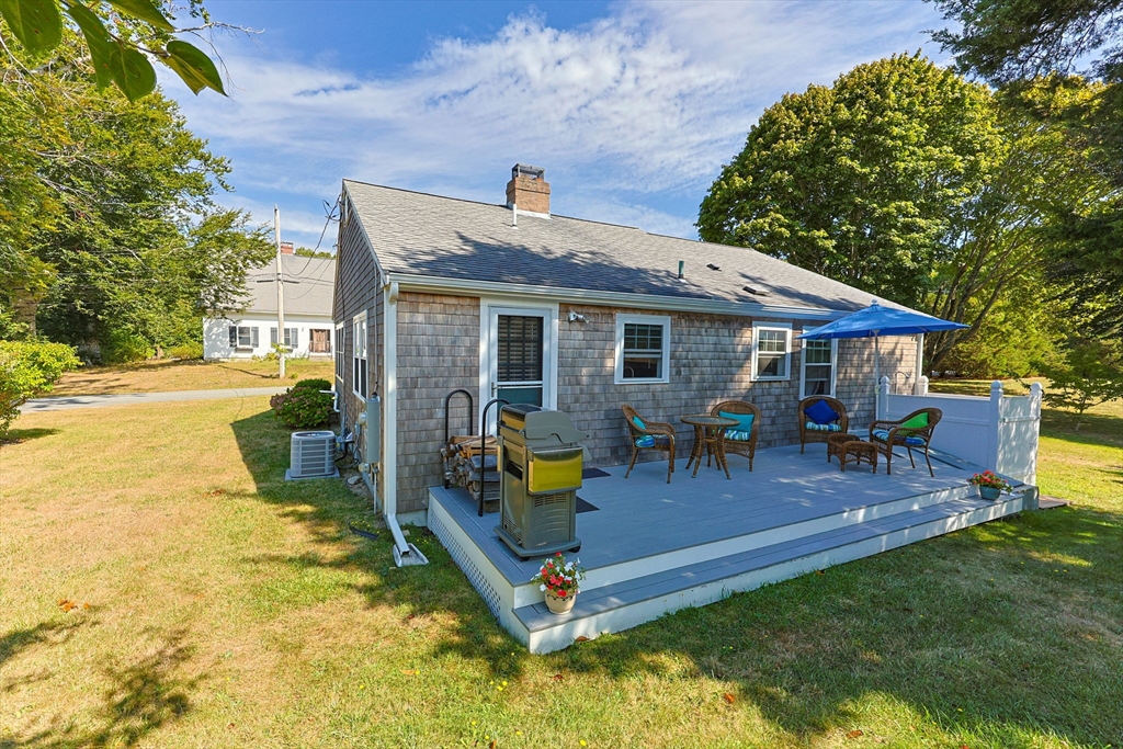 7 Spruce Drive Bourne, MA 02559 - Photo 24 of 39 a view of a house with a backyard patio and fire pit