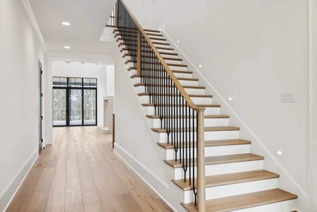 a view of an empty room with glass door and a window