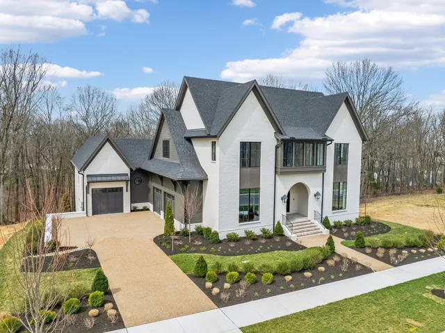 a view of a livingroom with wooden floor and a staircase