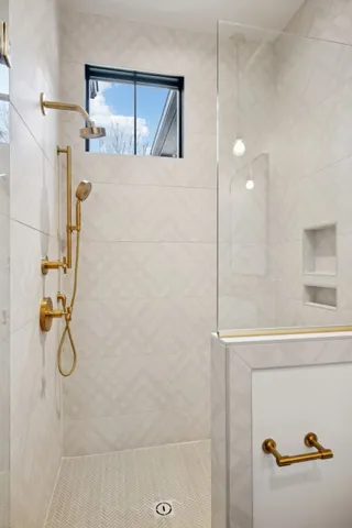 a view of an empty room with a fireplace and a window