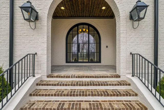 a view of an empty room with a fireplace and a window