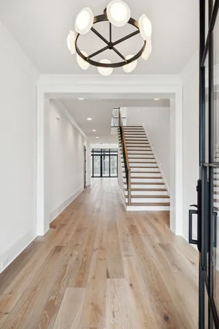 an empty room with wooden floor fireplace and windows