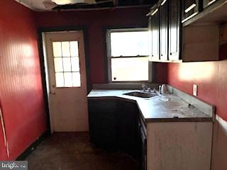 273 Broad Street Carneys Point, NJ 08069 - Photo 14 of 14 a kitchen with a sink a window and cabinets