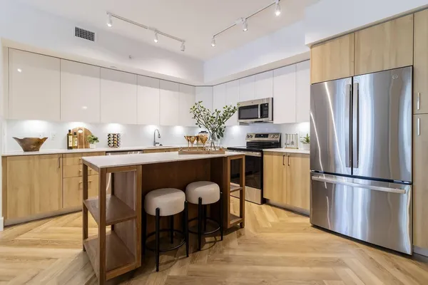 a kitchen with refrigerator cabinets dining table and chairs