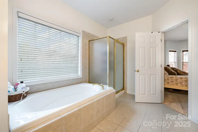 a spacious bedroom with a bed and a dresser