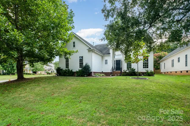 a front view of house with yard and green space