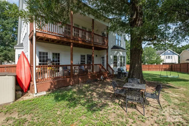 a view of a house with backyard porch and sitting area