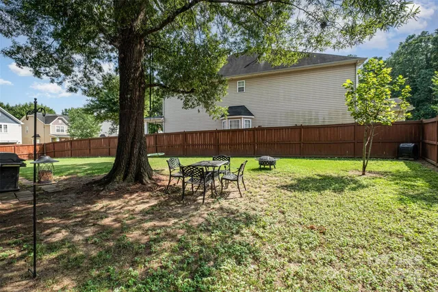 a view of a backyard with a table and chairs
