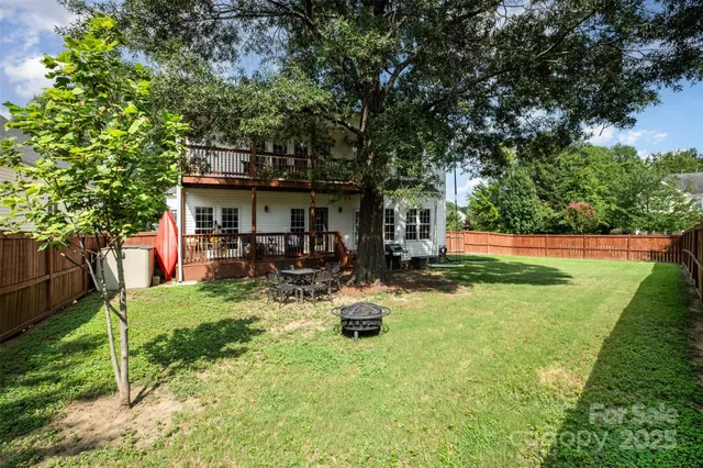 a view of backyard of house with green space