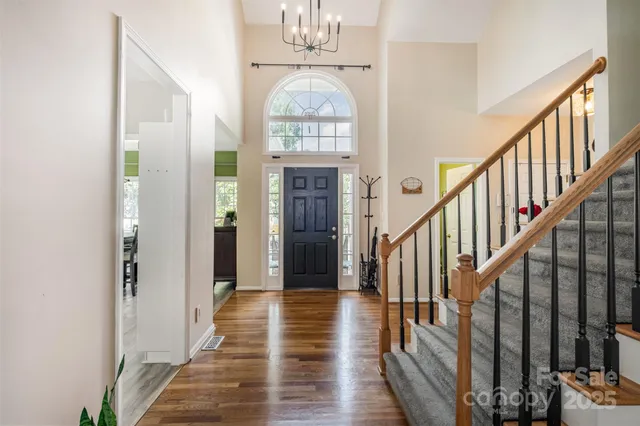 a view of entryway and hall with wooden floor
