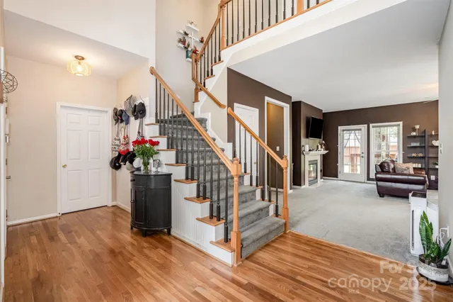 a view of entryway and hall with wooden floor