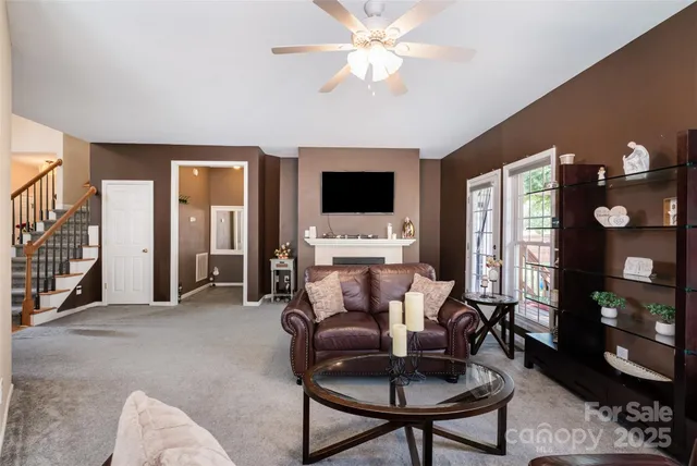 a view of a livingroom with furniture and a flat screen tv