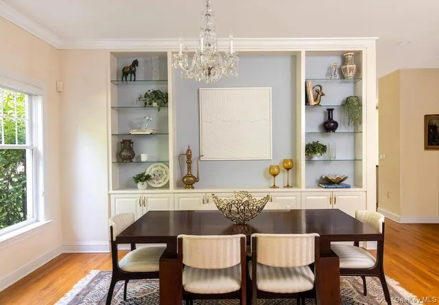 a kitchen with stainless steel appliances granite countertop a stove top oven a sink dishwasher and white cabinets with wooden floor