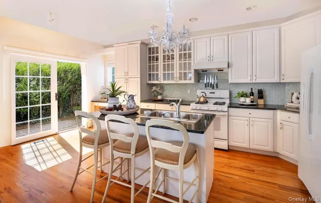 a kitchen with sink stove and cabinets