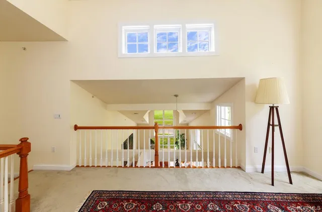 a living room with furniture and view of kitchen