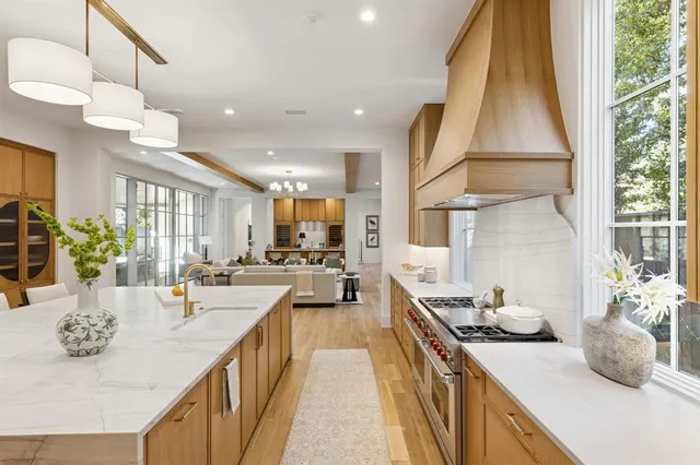 a kitchen with sink stove and cabinets