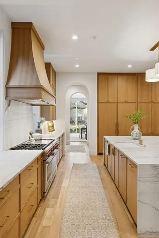 a large kitchen with kitchen island a sink stainless steel appliances and cabinets