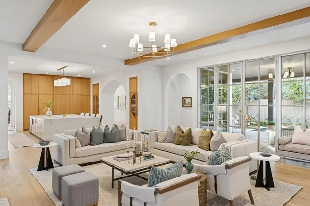 a living room with furniture and a chandelier