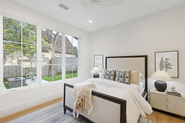 a bedroom with a bed and a large window