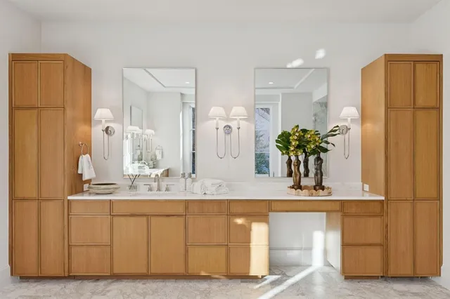 a bathroom with a double vanity sink and a mirror