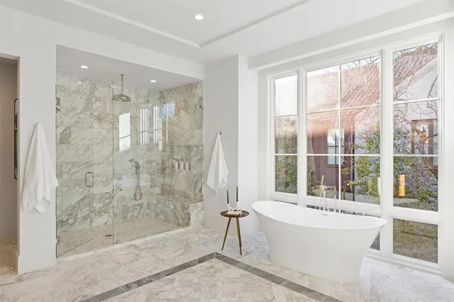 a bathroom with a bathtub and shower