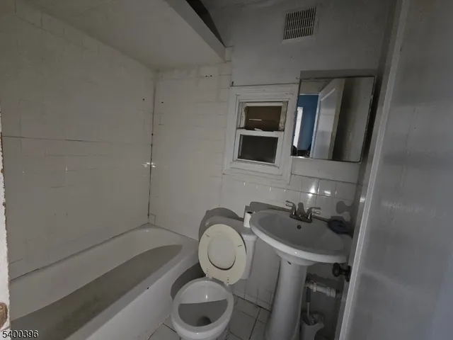 a bathroom with a toilet a sink and bathtub