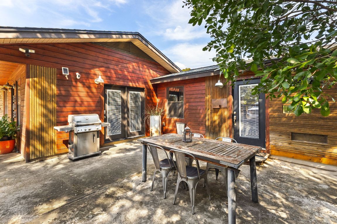 303 Lange Road Wimberley, TX 78676 - Photo 14 of 31 a backyard of a house with table and chairs