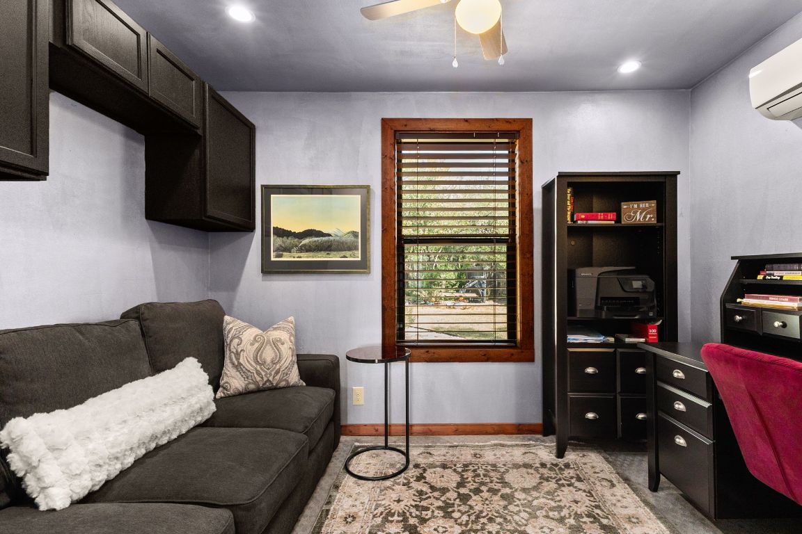303 Lange Road Wimberley, TX 78676 - Photo 17 of 31 a living room with furniture and a window