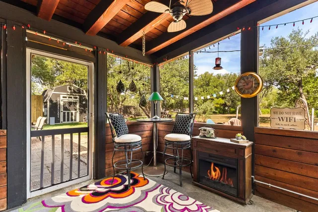 a view of a lake with lawn chairs and a fire pit