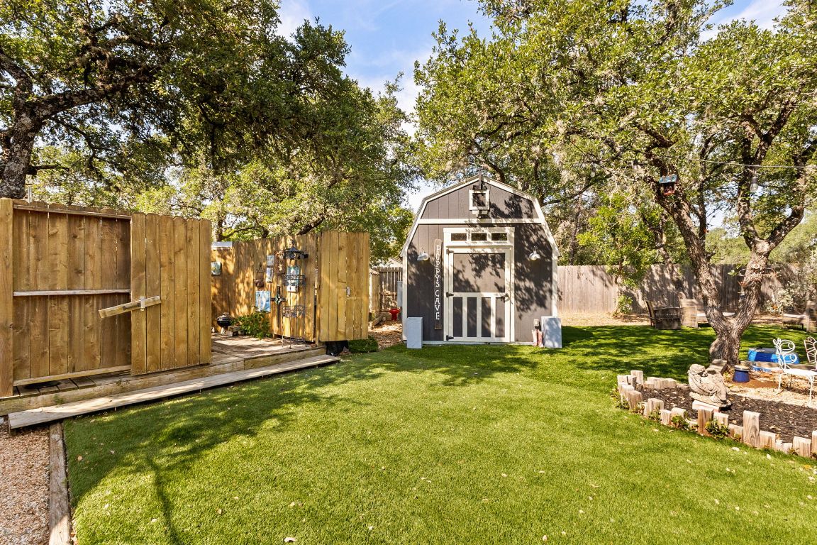 303 Lange Road Wimberley, TX 78676 - Photo 27 of 31 a view of a house with a big yard and large trees