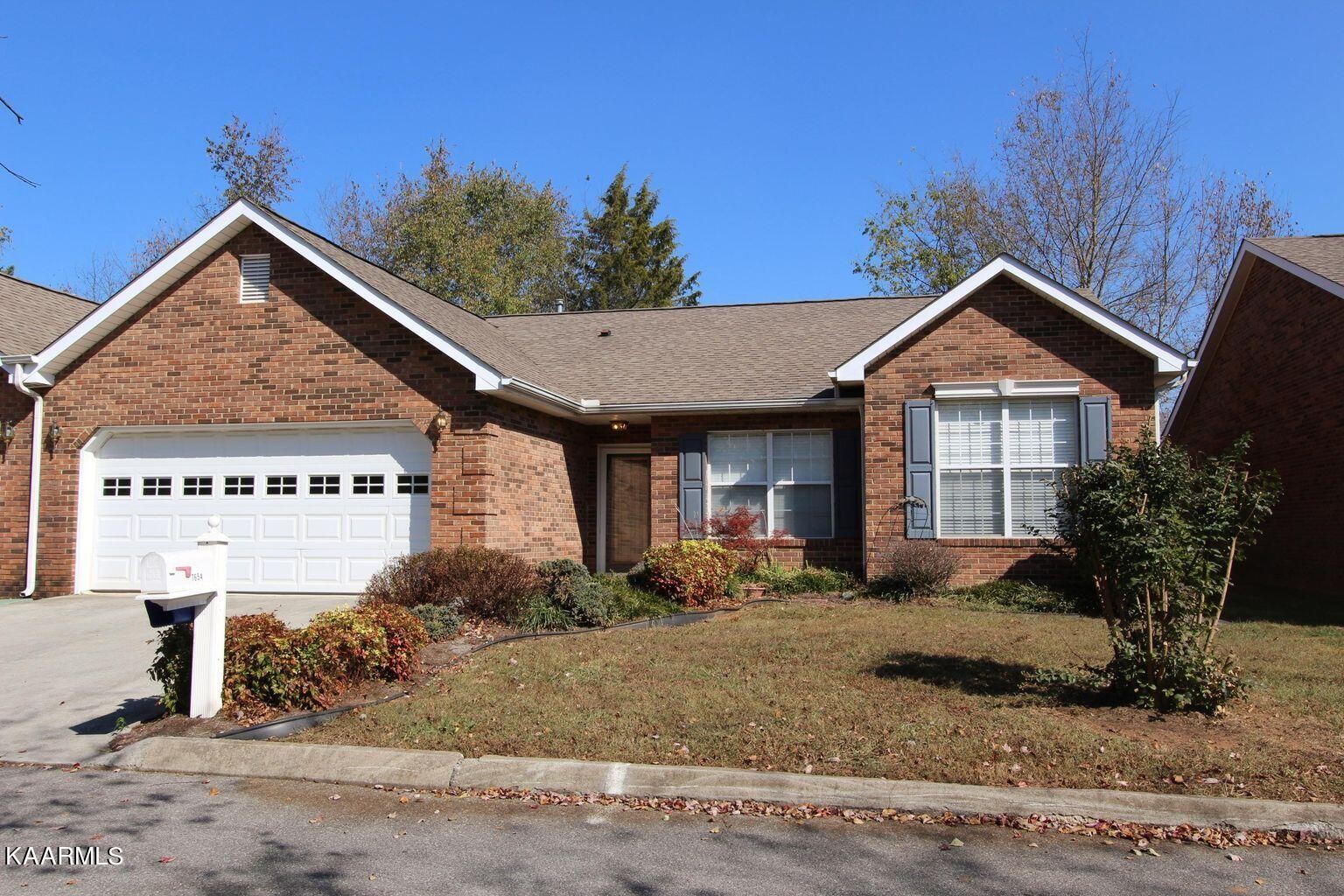7654 Wren Garden Way Powell, TN 37849 - Photo 1 of 1 a front view of a house with garden
