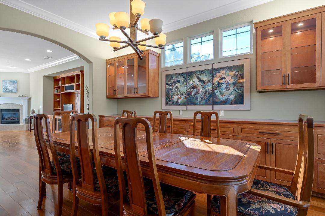 3685 Wimbledon Drive Redding, CA 96002 - Photo 11 of 70 a view of a dining room with furniture a chandelier and wooden floor