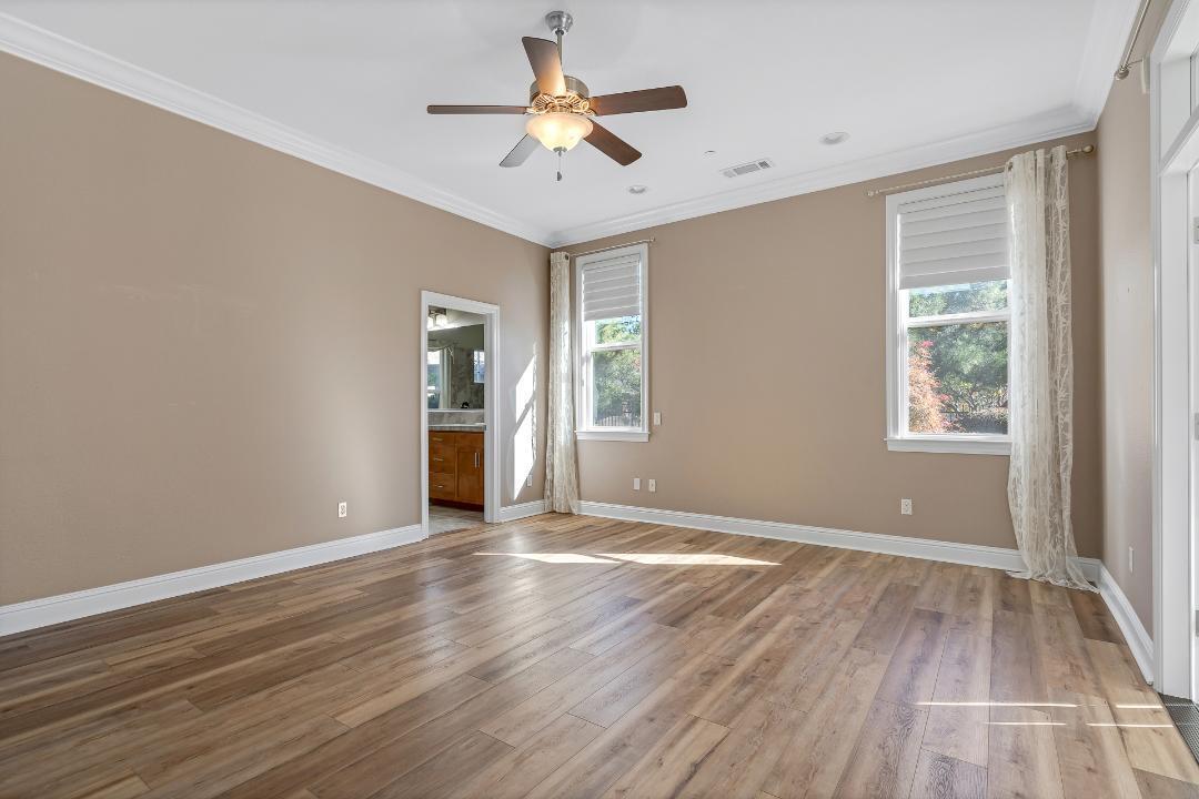 3685 Wimbledon Drive Redding, CA 96002 - Photo 43 of 70 a view of empty room with wooden floor and fan